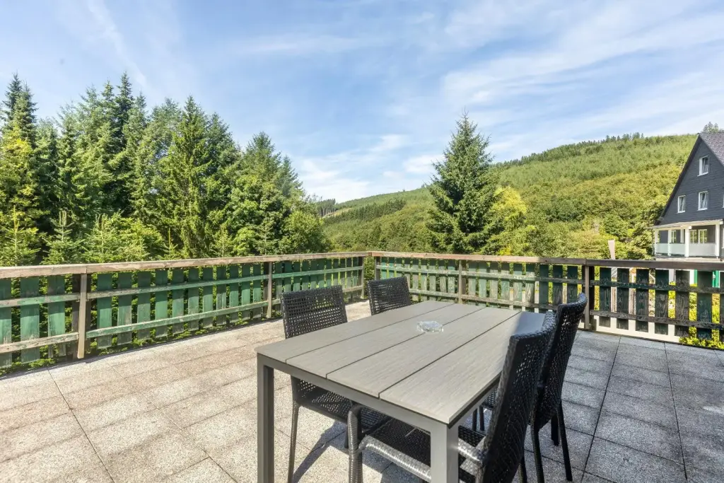 Terrasse mit Sitzgruppe und weitem Blick über die bewaldeten Hügel des Sauerlands